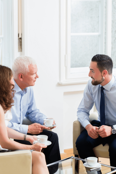 Professional financial adviser meeting with a family in a modern office.